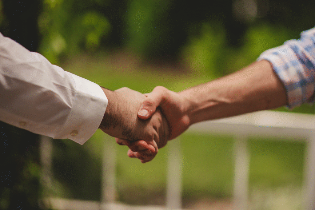 George and a homeowner shaking hands as they close a deal